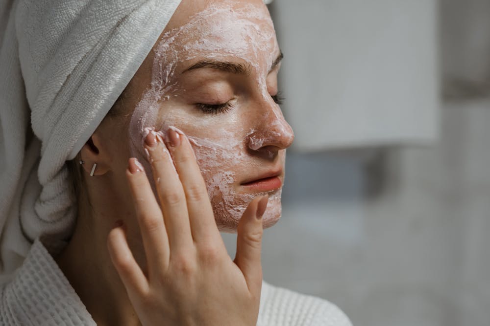 woman putting clay mask